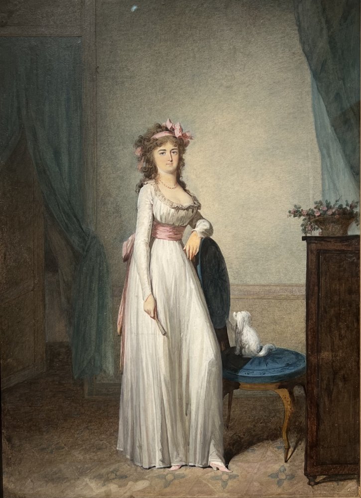 Young woman holding a fan and her dog in an interior